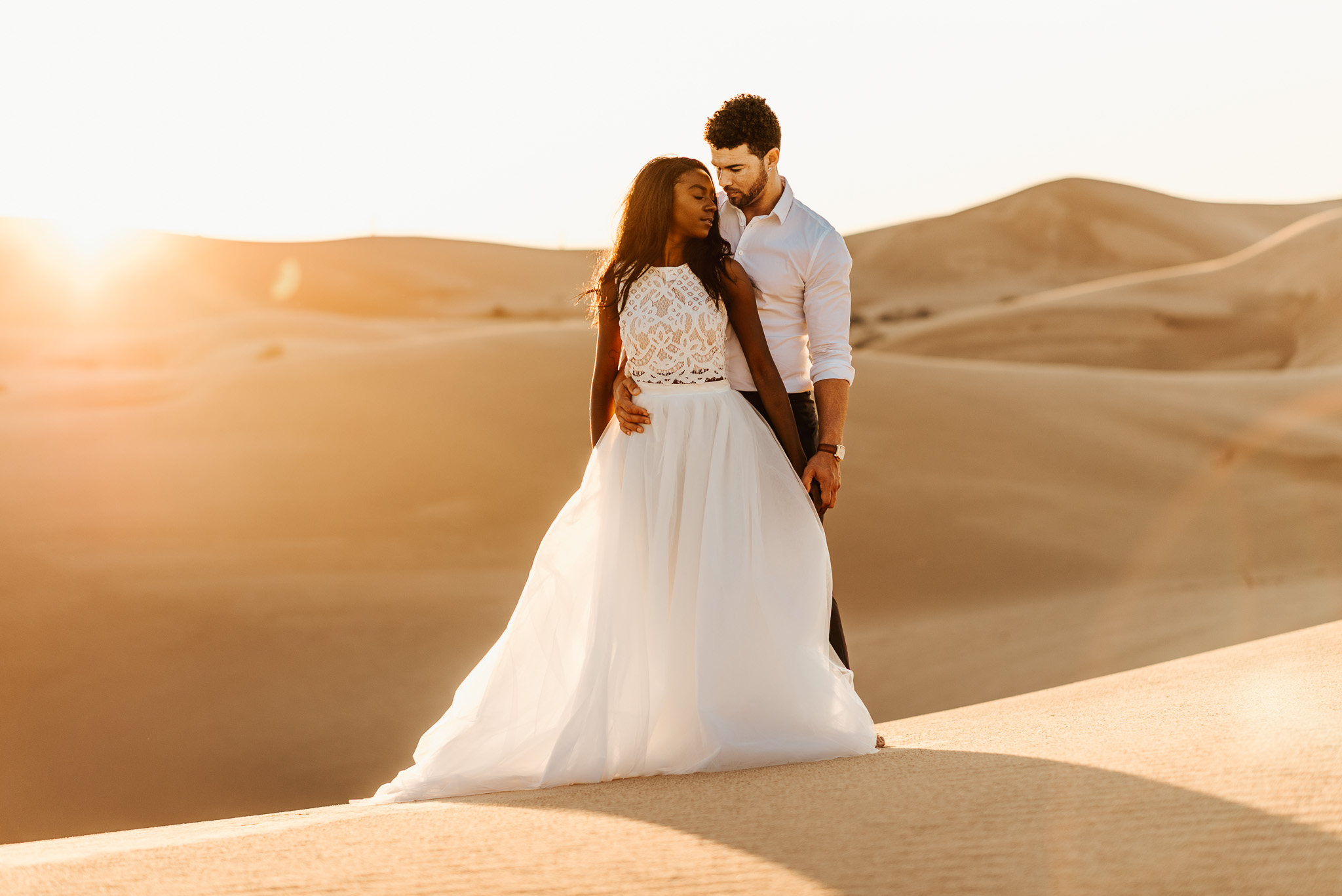 bride and groom at the sand dunes at sunset